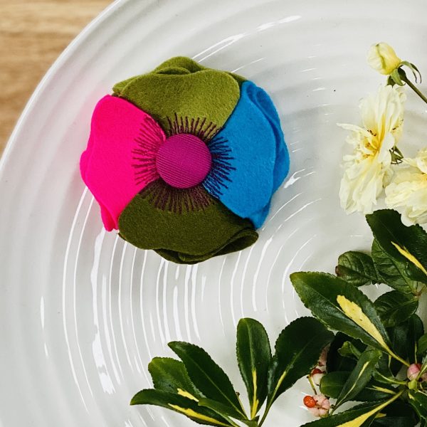 Petunia merino wool lapel brooch on a green jacket