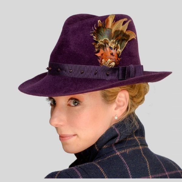 Aubergine fedora with feather hat pin - side view