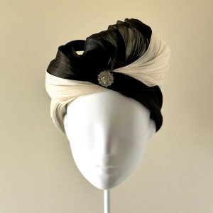 Tiffany – a turban in ivory and black silk abaca finished with a semi-bow facing